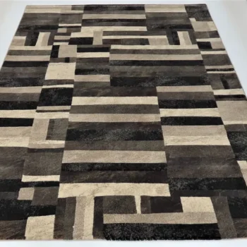 Cambridge Prestige Rug with a geometric pattern made up of rectangles and squares in various shades of brown, black, and cream
