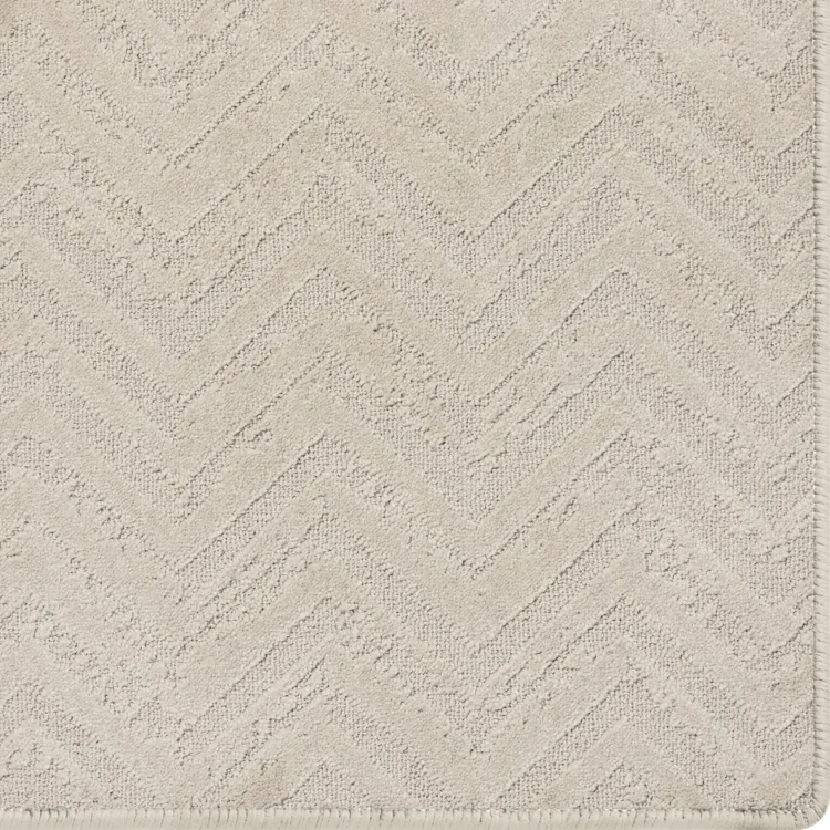 Dove cream rug with relic pattern and overlocked edges