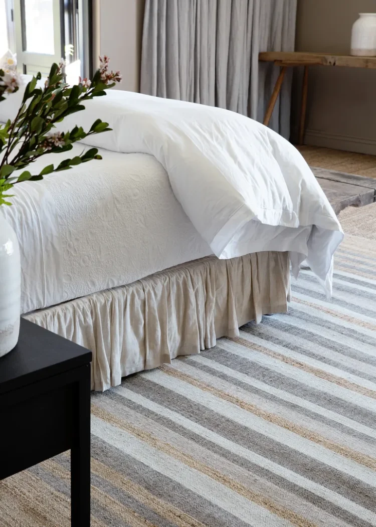 multi coloured solid striped rug in bedroom