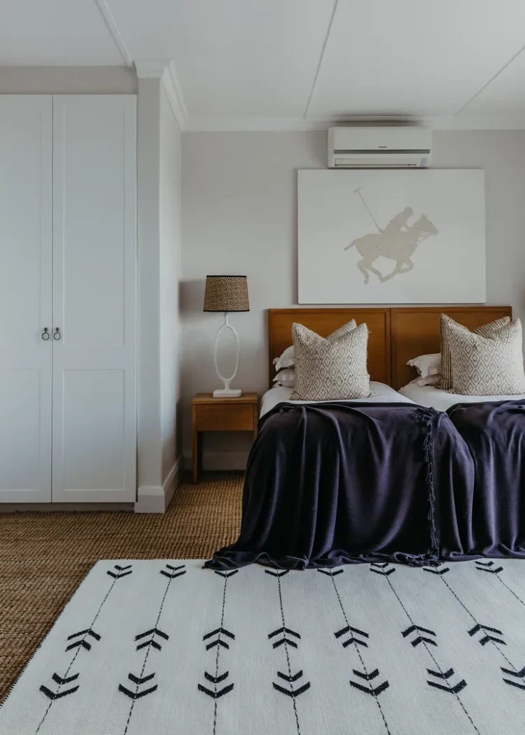 white rug with black arrows in a bedroom