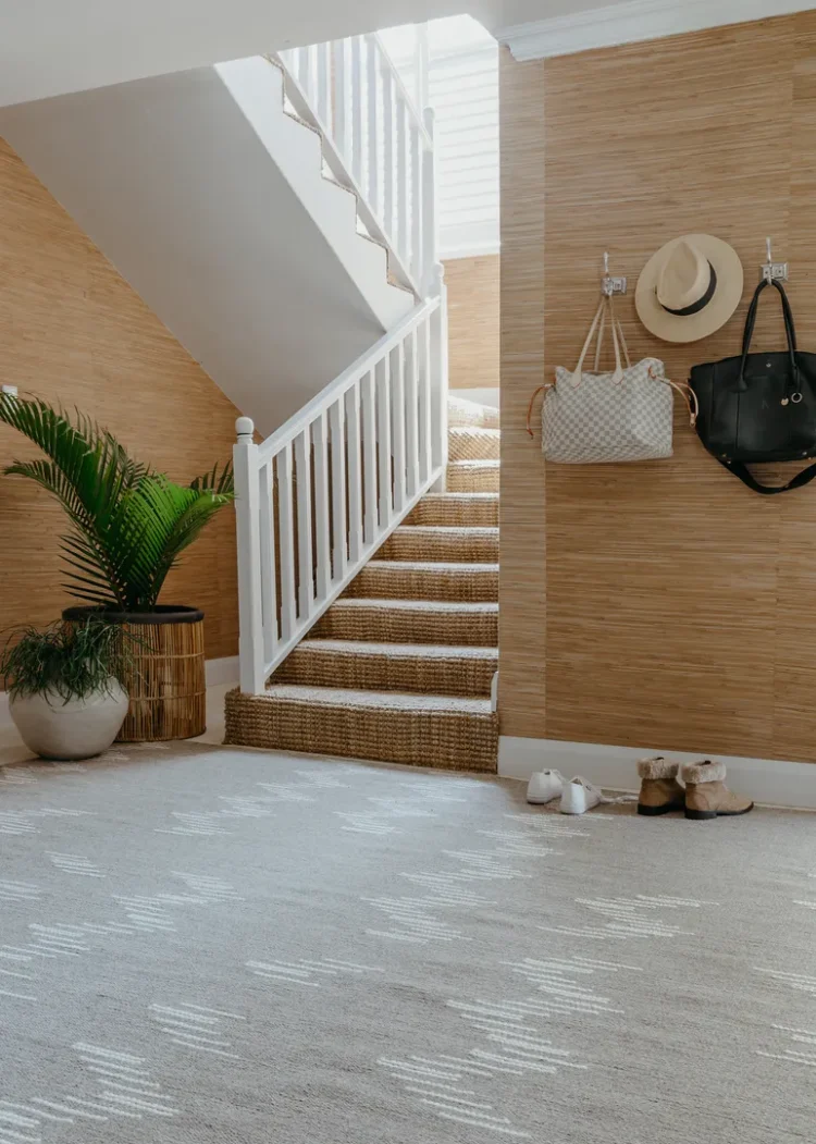 brown rug with cream zig zag pattern on the floor next to the stairs