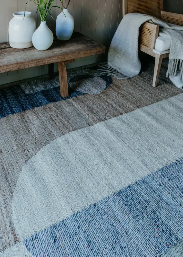 abstract multi colour rug with wooden chair and table