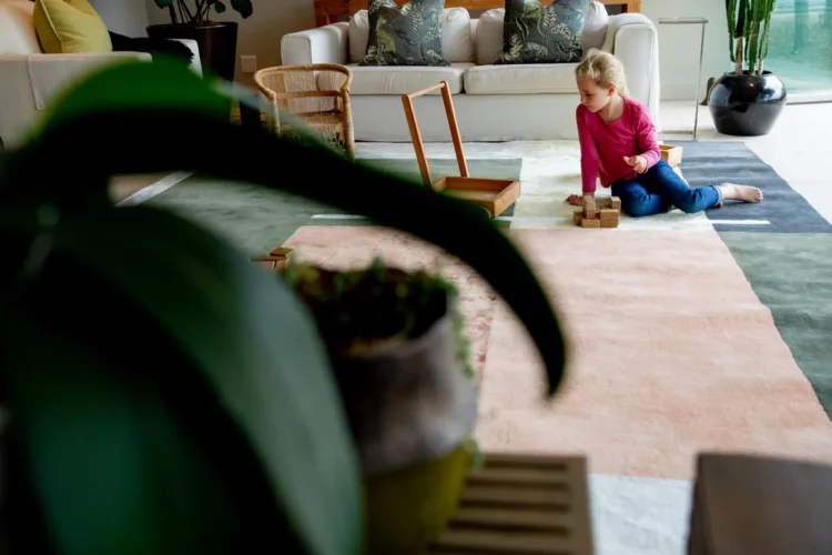 multi colour geometric rug with little girl playing on it