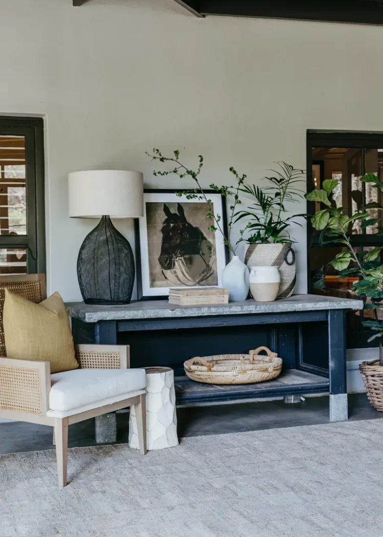 a table with a lamp and a picture on it on top of jute rug