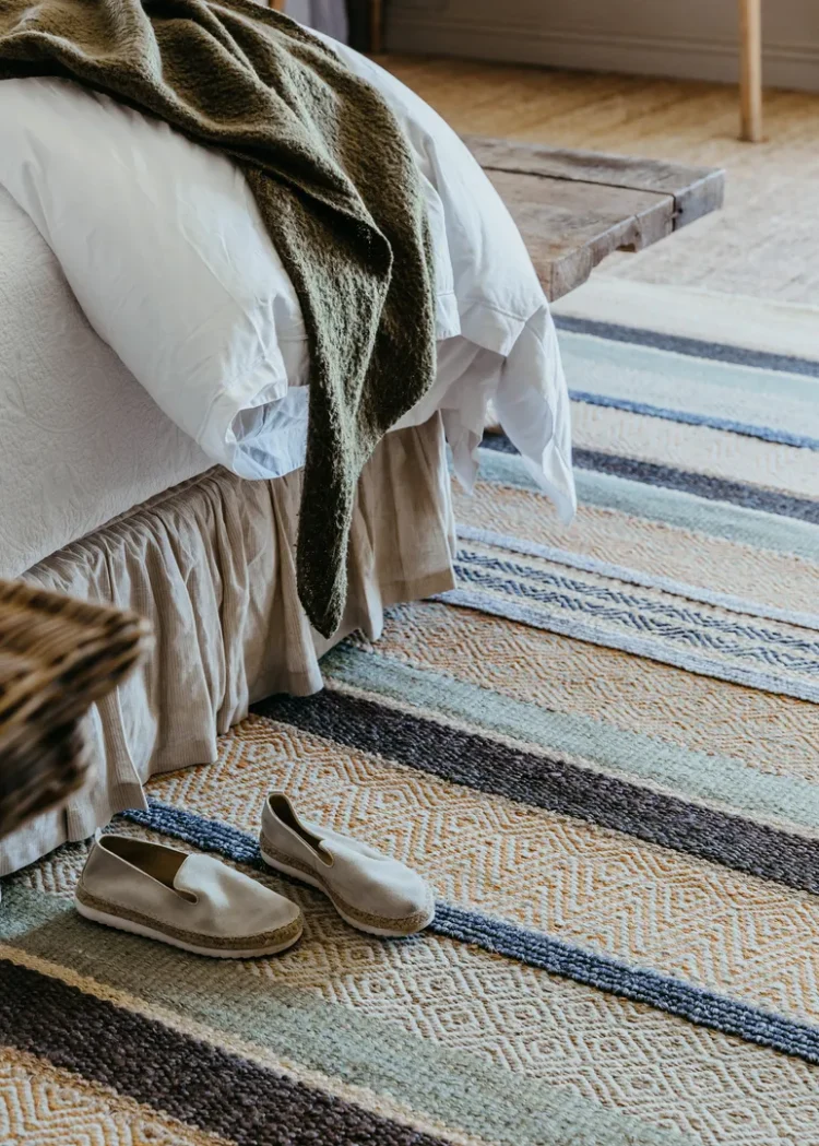 a pair of shoes on a striped Desert rug