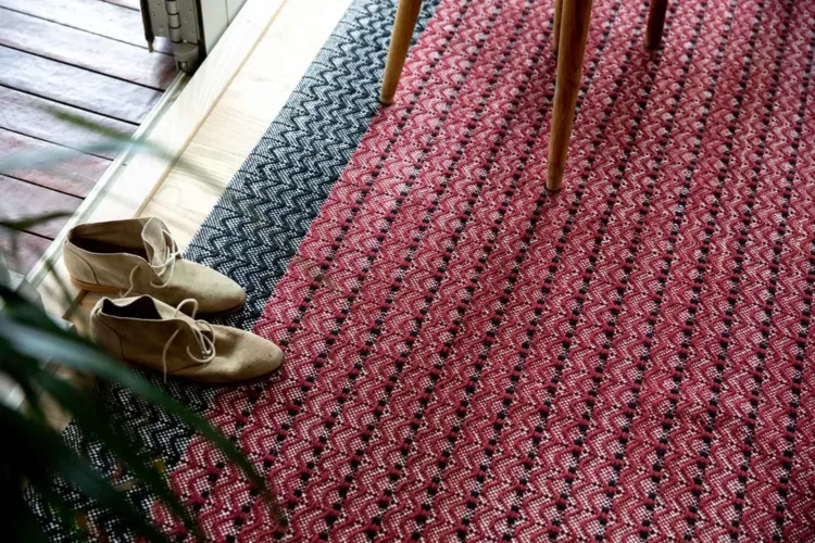 a pair of shoes on a dune wine rug