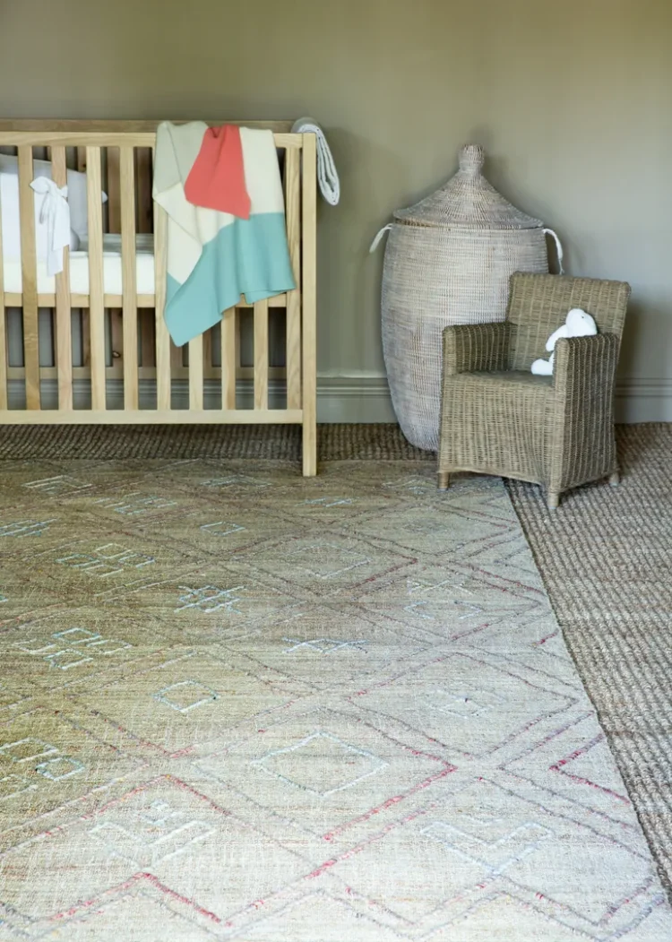 a baby crib in a room on a kimberley rug