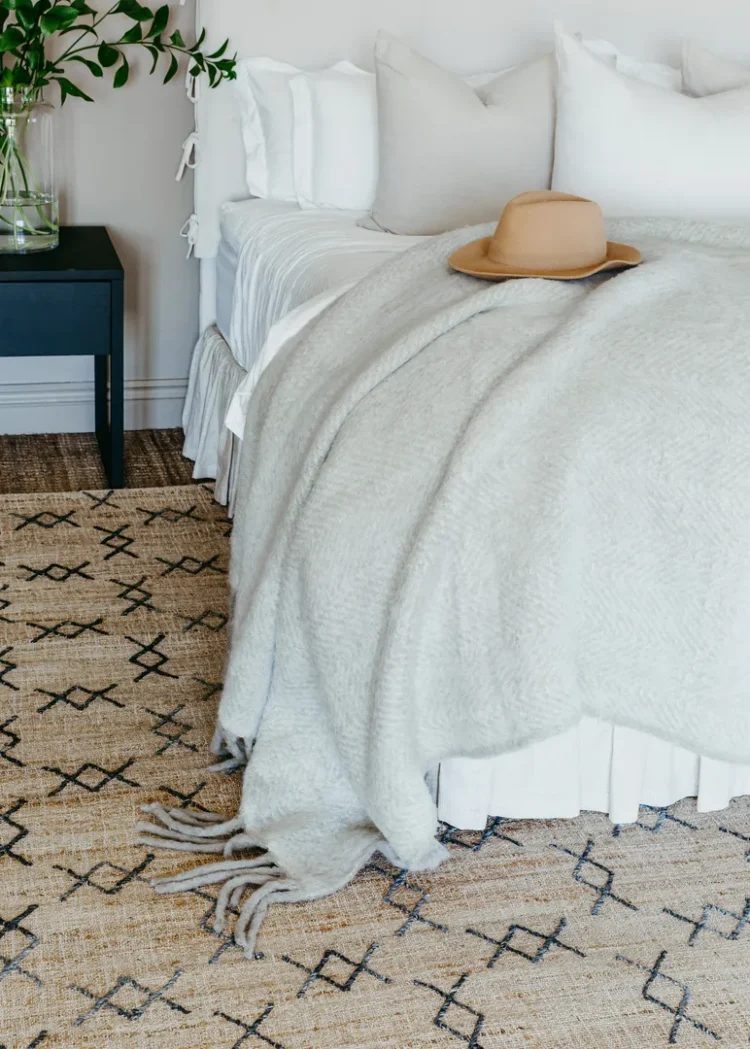 a hat on a blanket on a bed