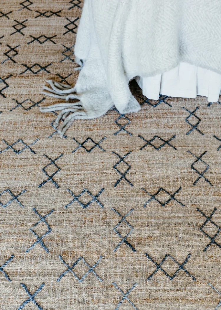 a kudu rug with a white blanket on it