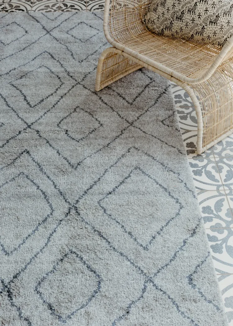 a lingala light rug and chair in a room