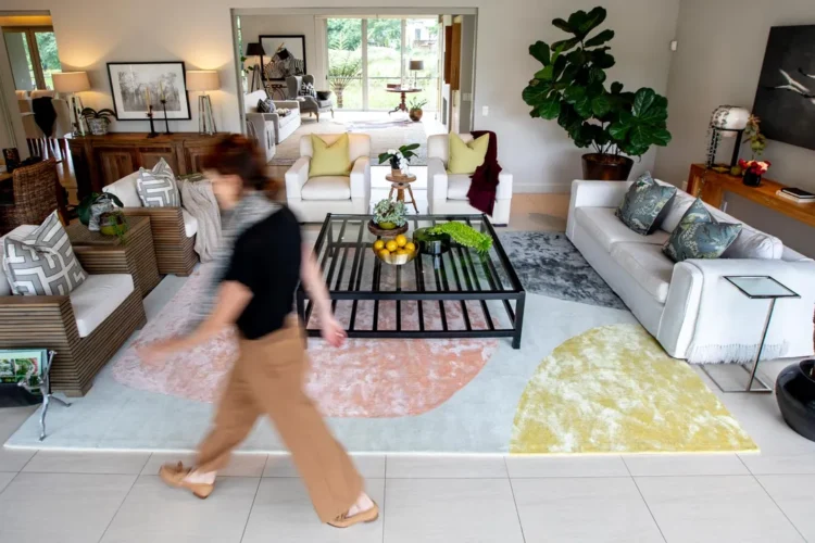 Woman walking through lounge with marriage rug on floor