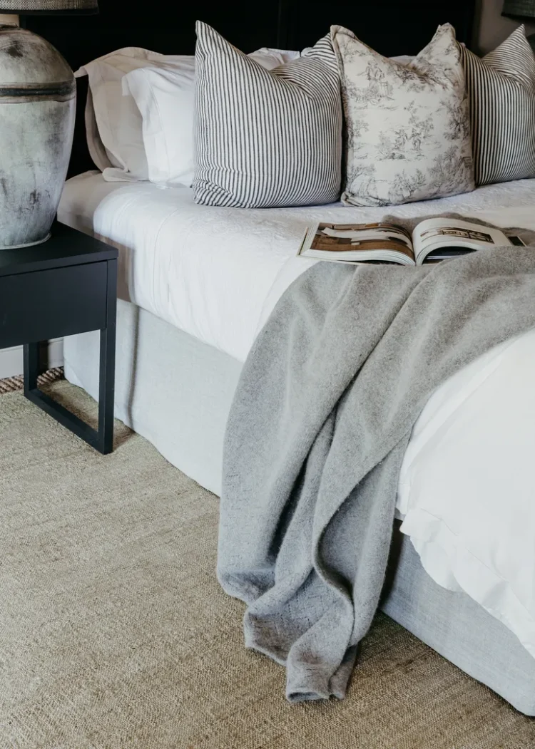 bed and side table on jute rug